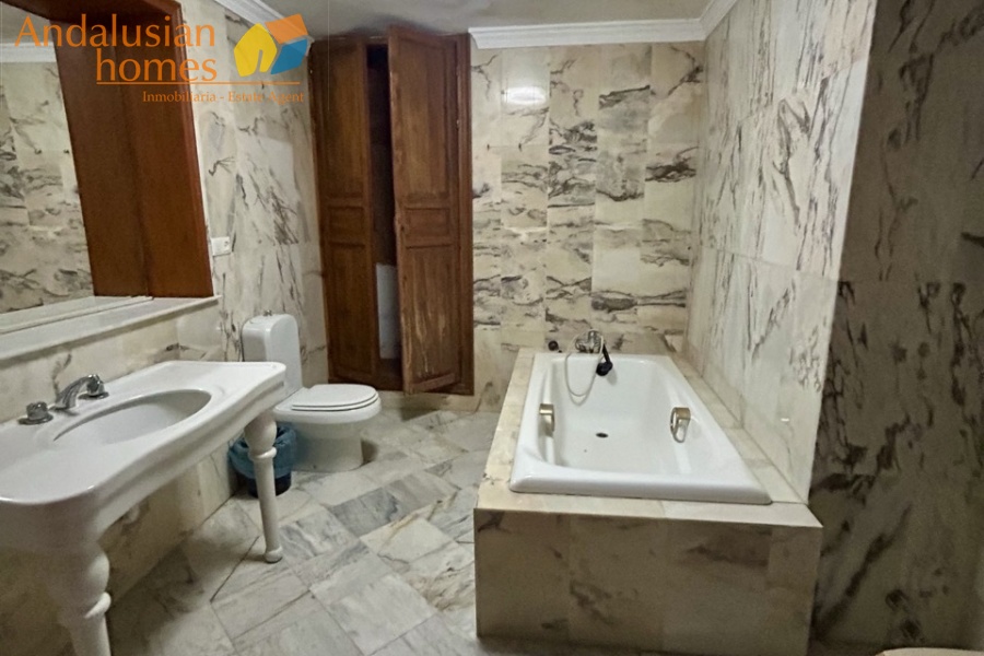 historic townhouse, Andalusian property, townhouse for sale Spain, renovation project, investment property, boutique hotel potential, town square property, property with terraces, garage included, mountain views, character building, development opportunity, rental potential