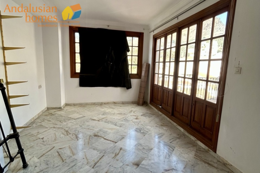 historic townhouse, Andalusian property, townhouse for sale Spain, renovation project, investment property, boutique hotel potential, town square property, property with terraces, garage included, mountain views, character building, development opportunity, rental potential