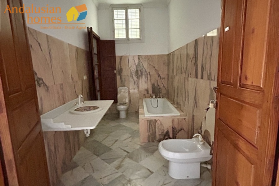 historic townhouse, Andalusian property, townhouse for sale Spain, renovation project, investment property, boutique hotel potential, town square property, property with terraces, garage included, mountain views, character building, development opportunity, rental potential