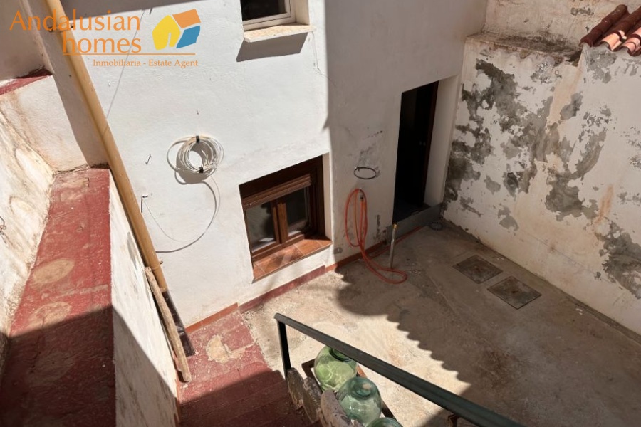 View of house and patio from upper terrace