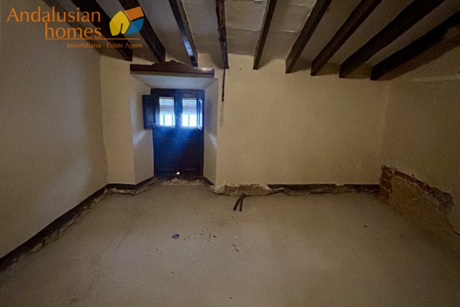 Front Bedroom with sloping beamed ceiling 