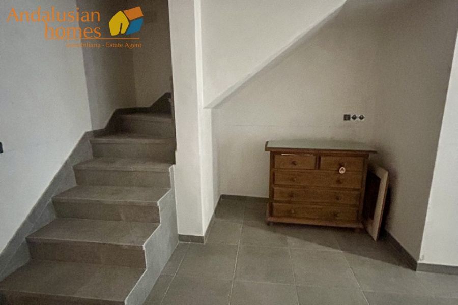 Open plan reception room with stairs up
