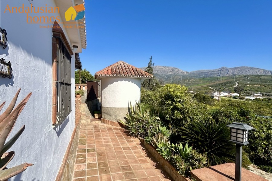 Country home, Álora, Las Mellizas, Málaga countryside, detached villa, olive grove, 4000m2 plot, private pool, panoramic views, terraces, fenced plot, parking, fireplace, ensuite bedroom, outdoor living, rural retreat, train access, investment property, holiday rental, tourism potential, Andalusian property, peaceful location, close to El Chorro, near Málaga coast
