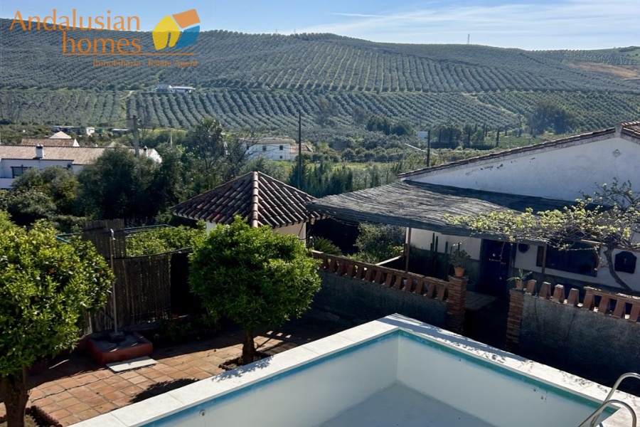 Country home, Álora, Las Mellizas, Málaga countryside, detached villa, olive grove, 4000m2 plot, private pool, panoramic views, terraces, fenced plot, parking, fireplace, ensuite bedroom, outdoor living, rural retreat, train access, investment property, holiday rental, tourism potential, Andalusian property, peaceful location, close to El Chorro, near Málaga coast